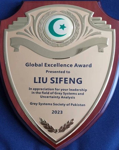 Image shows an award. It reads "Global Excellence Award presented to Liu Sifeng in appreciation for your leadership in the field of Grey Systems and Uncertainty Analysis. Grey Systems Society of Pakistan 2023